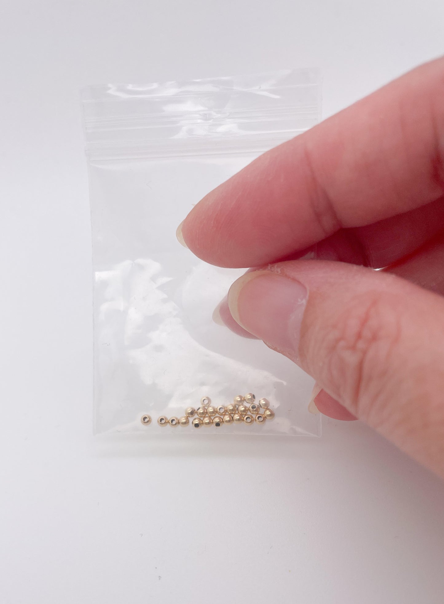Gold filled kraaltjes 2 mm zakje van 25 stuks